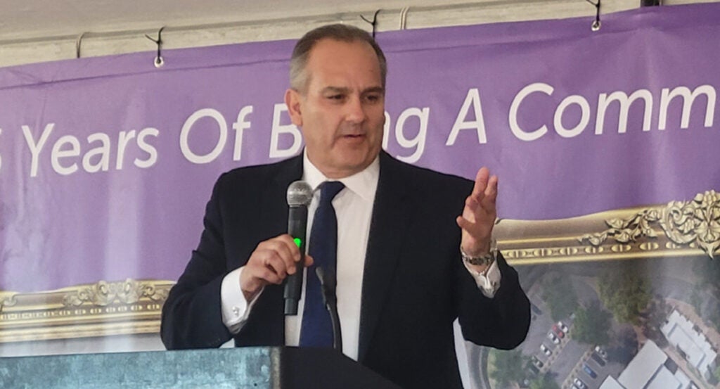 Clark County, Nevada, superintendent Jesus Jara stands in a suit holding a microphone