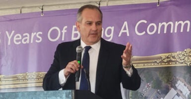 Clark County, Nevada, superintendent Jesus Jara stands in a suit holding a microphone