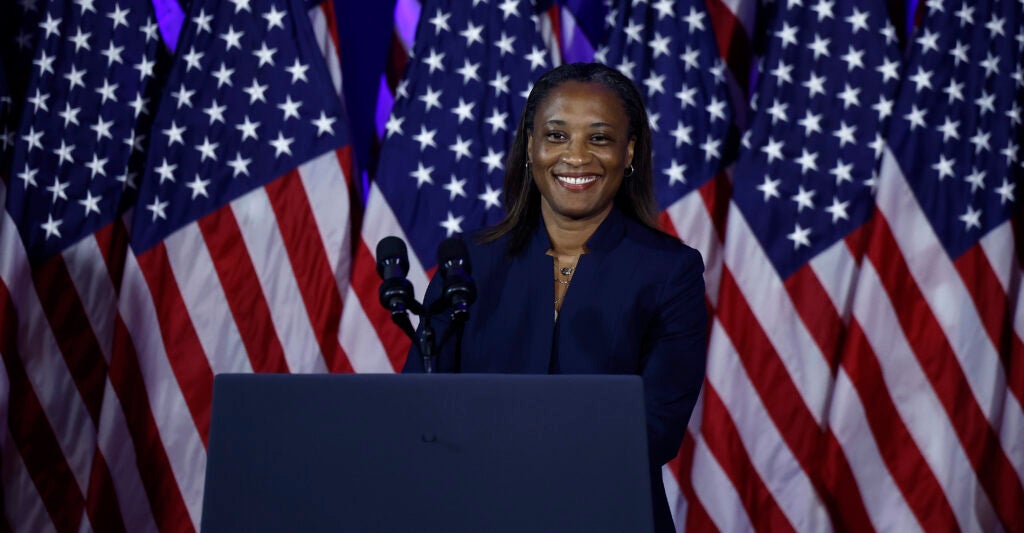 Laphonza Butler in front of American flags