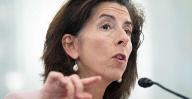 Gina Raimondo wearing earrings speaks during testimony