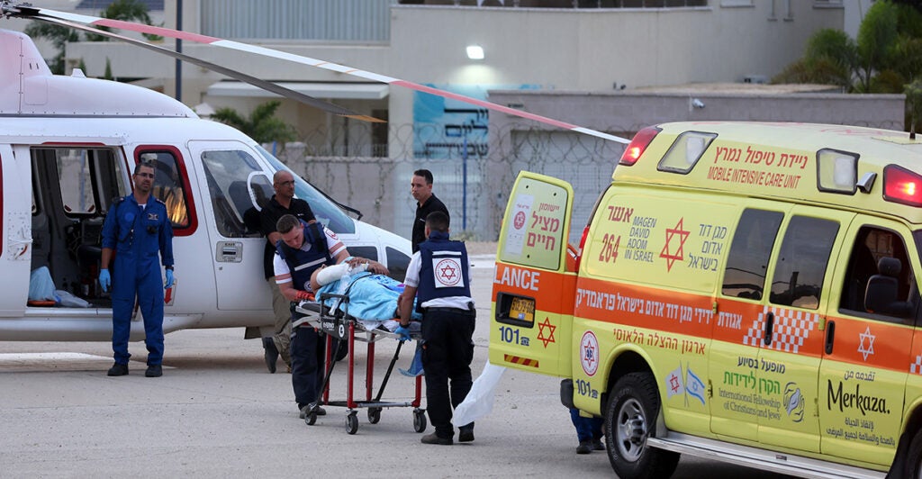 Medical personal transport an injured person from a medical vehicle to a helicopter in Israel.