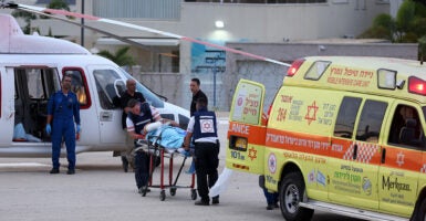 Medical personal transport an injured person from a medical vehicle to a helicopter in Israel.