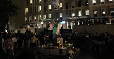 Students holding a vigil for Hamas outside on a college campus at night