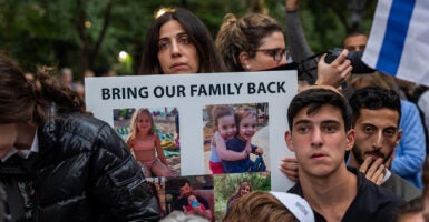 Supporters of Israel outside for a vigil holding posters