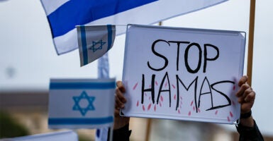 Demonstrators wave Israeli flags and a 