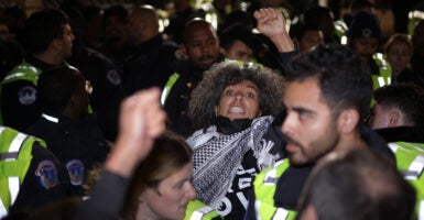 Capitol Police escort an anti-Israel protester away from the DNC