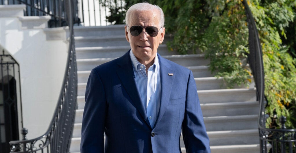 President Joe Biden in sunglasses and a blue suit