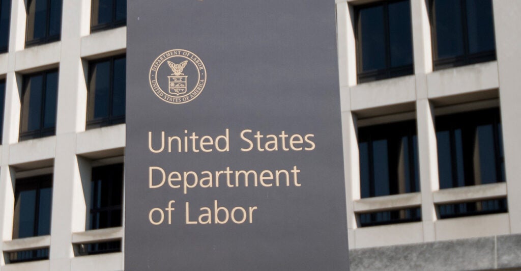 U.S. Labor Dept. headquarters building with Labor Dept. sign in front.