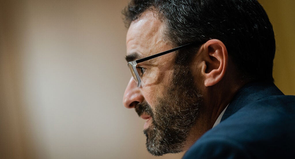 IRS Commissioner Danny Werfel in a suit wearing glasses and a salt-and-pepper beard