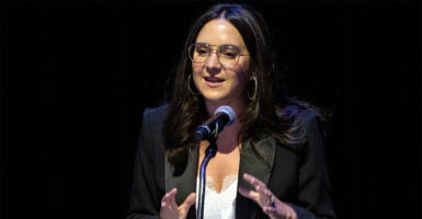 Bari Weiss speaking at a microphone