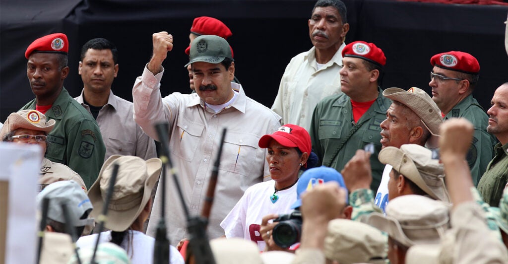 Venezuelan President Nicolas Maduro in the middle of a crowd dressed in military fatigues