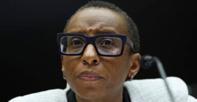 Claudine Gay, President of Harvard University, testifying at a microphone before Congress