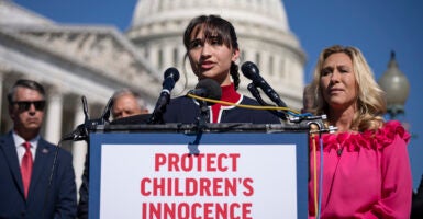 Detransitioner Chloe Cole speaks wearing red and blue at the Capitol building