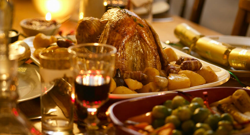 Turkey, wine, and other food at a Christmas dinner table