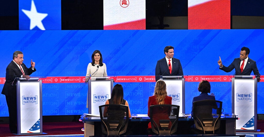 Former New Jersey Gov. Chris Christie, former South Carolina Gov. and U.N. Ambassador Nikki Haley, Florida Gov. Ron DeSantis and entrepreneur Vivek Ramaswamy stand on the debate stage at their podiums.