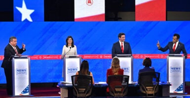 Former New Jersey Gov. Chris Christie, former South Carolina Gov. and U.N. Ambassador Nikki Haley, Florida Gov. Ron DeSantis and entrepreneur Vivek Ramaswamy stand on the debate stage at their podiums.