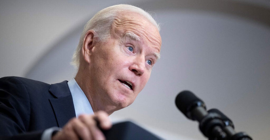 President Joe Biden speaks at a podium.