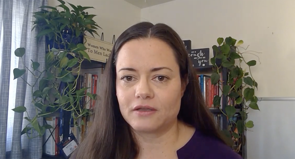 Nicole Marie Prussman in front of books