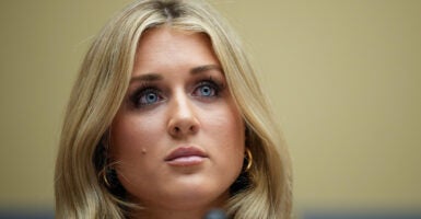 Riley Gaines looks ahead while seated as she testifies before Congress.