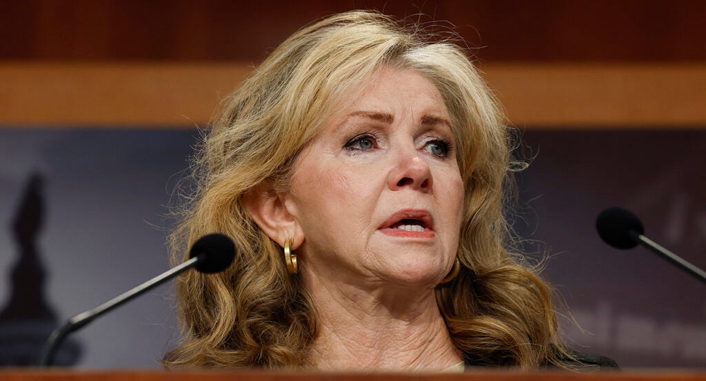 Marsha Blackburn speaks behind two microphones