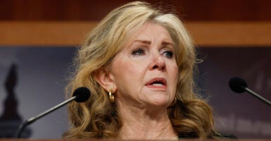 Marsha Blackburn speaks behind two microphones