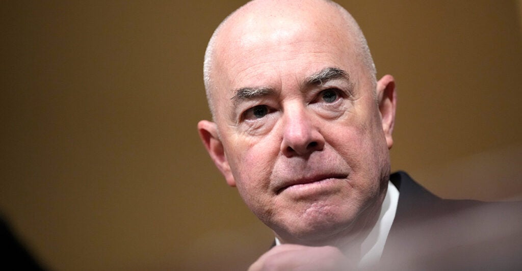 Close-up of Homeland Security Secretary Alejandro Mayorkas shows him in a suit coat during a hearing.