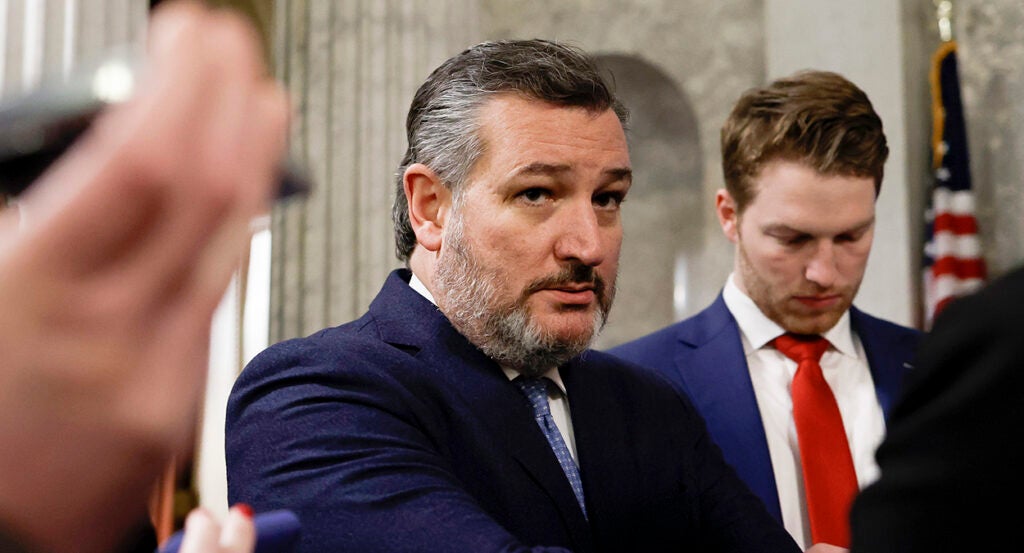 Sen. Ted Cruz stares intently while wearing a blue suit