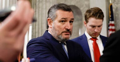 Sen. Ted Cruz stares intently while wearing a blue suit