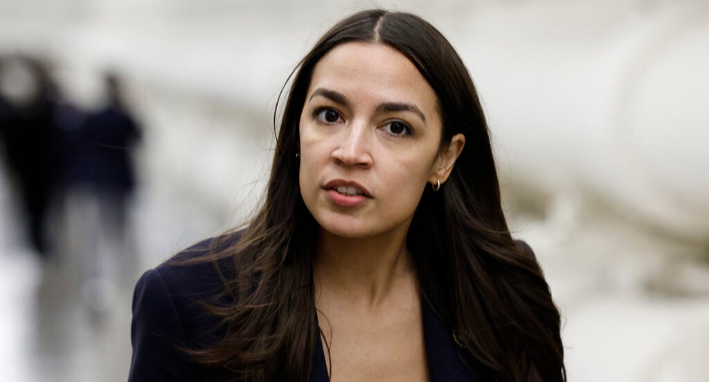 Alexandria Ocasio-Cortez in black in the halls of Congress