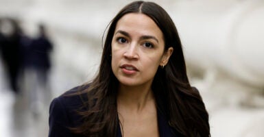 Alexandria Ocasio-Cortez in black in the halls of Congress