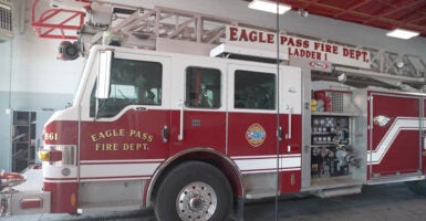 A firetrucks sits in a fire house.