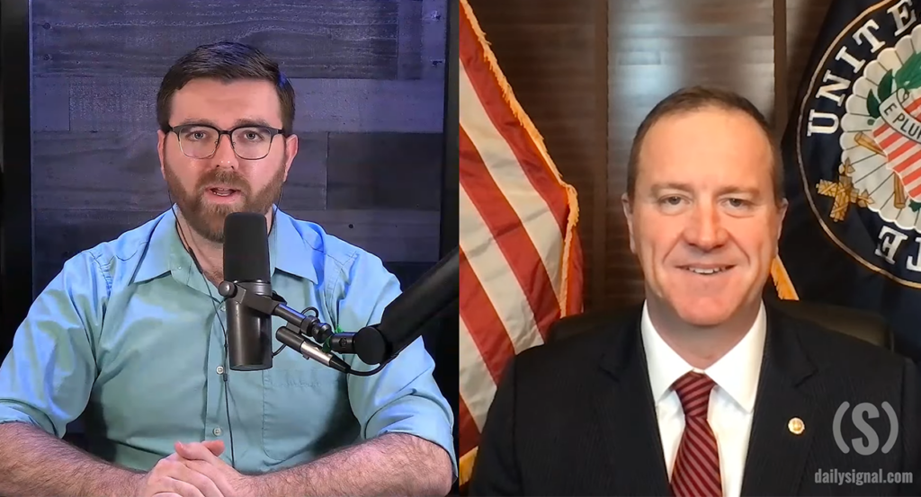 Split screen with Daily Signal reporter Tony Kinnett on a microphone on the left side interviewing Senator Eric Schmitt in a suit and tie on the right side