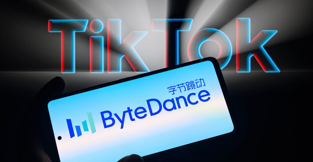 A phone displays the "ByteDance" name in front of the words "TikTok" glowing in blue and red.