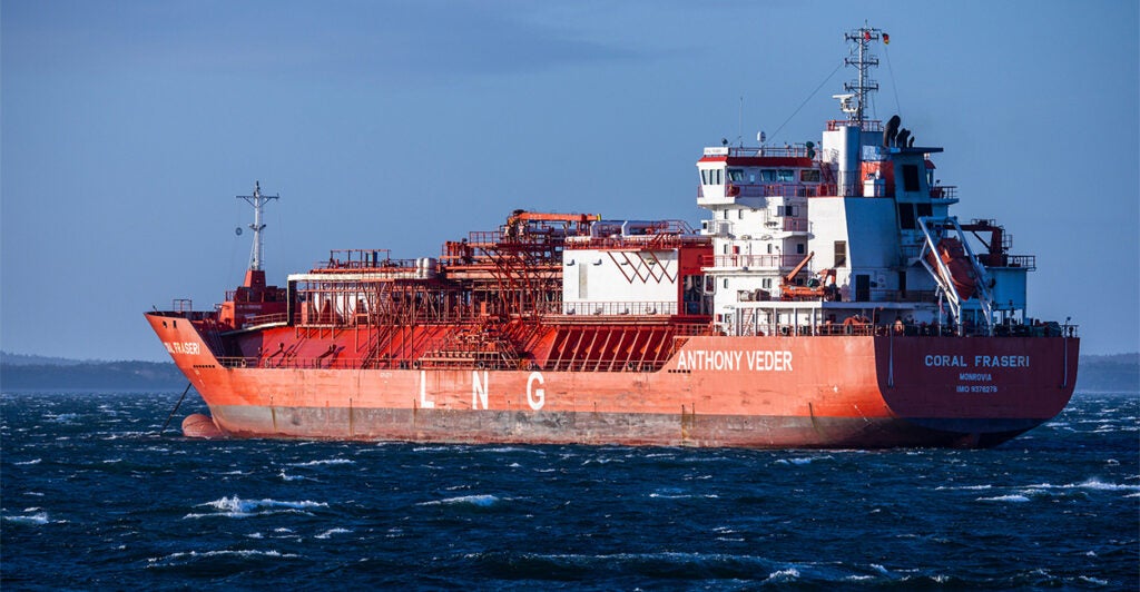 An oil tanker floats in the middle of the ocean.