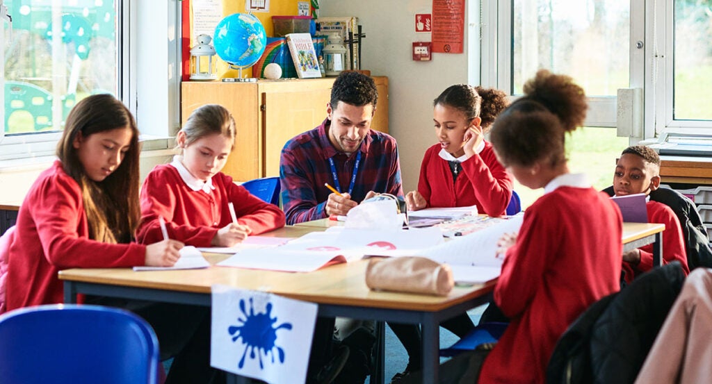 Elementary school students drawing in a classroom