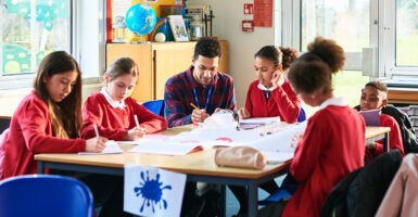 Elementary school students drawing in a classroom