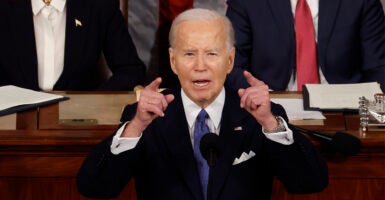 President Biden Delivers State Of The Union Address, raising both arms to emphasize a point