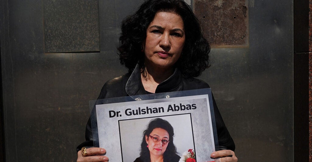 Rushan Abbas holds a photo of her abducted sister