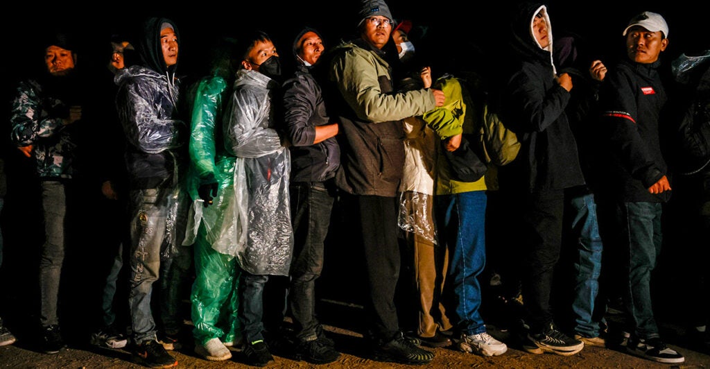 Chinese nationals huddle after crossing the U.S.-Mexico border.