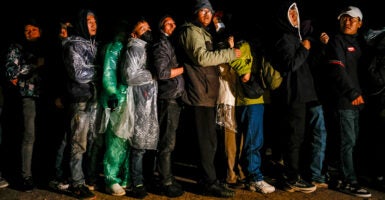 Chinese nationals huddle after crossing the U.S.-Mexico border.