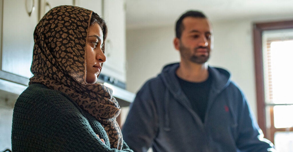 Afghani husband and wife in their apartment kitchen in the U.S.