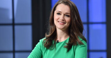 Carrie Sheffield smiles in a green dress.