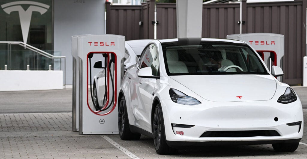 An electric car parked at a charging station.