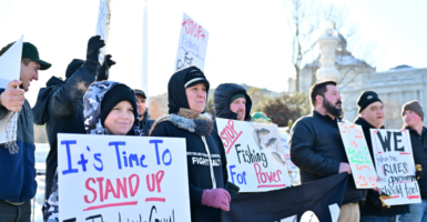 Fishermen and their families protest at the Supreme Court