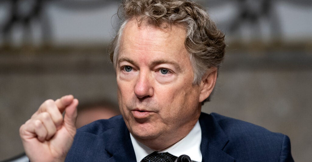 Sen. Rand Paul speaking behind his desk at a hearing.