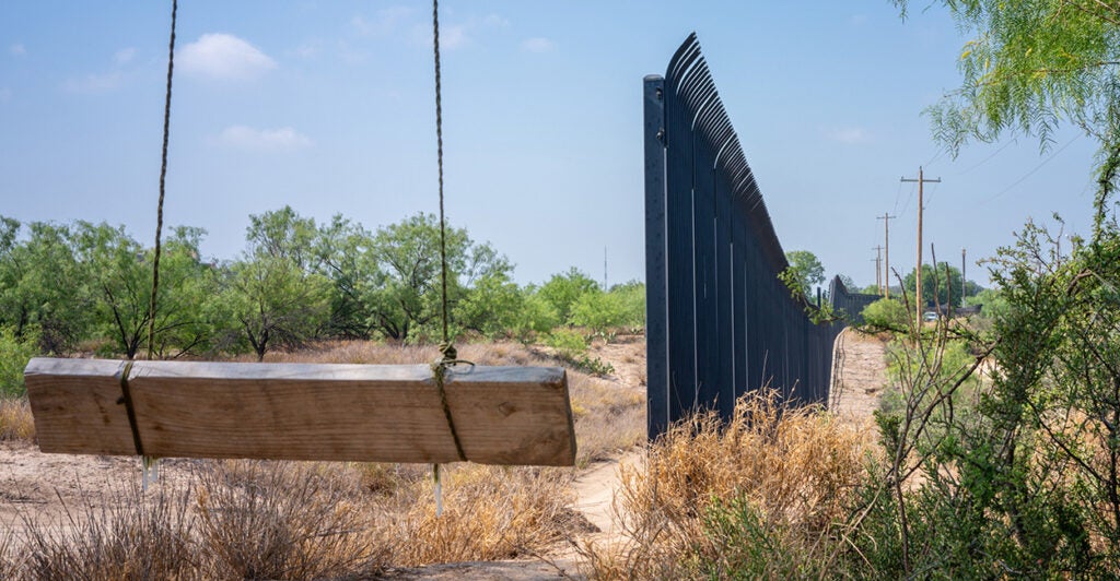 n empty swing overlooks a section of border fencing near the banks of the Rio Grande river in Eagle Pass, Texas.