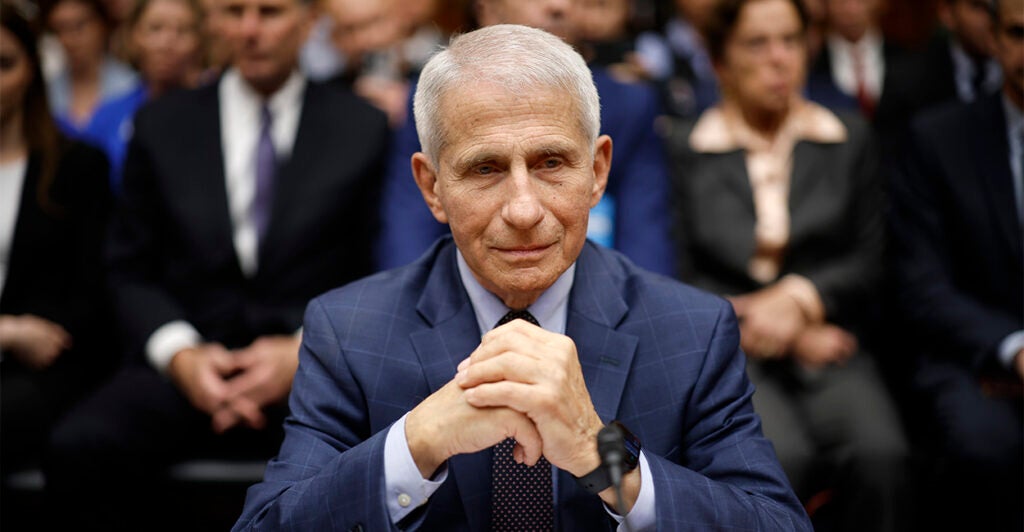 anthony fauci sitting at a witness table in a house hearing room