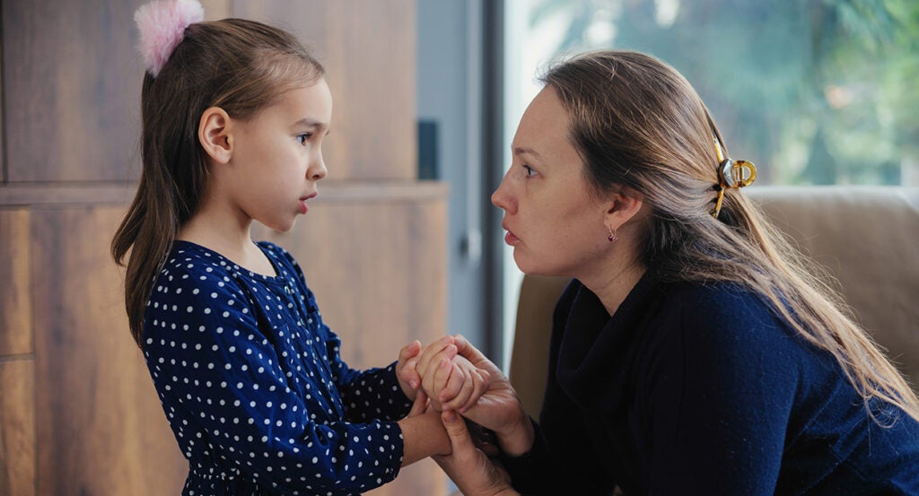 A mom consoles her young daughter.