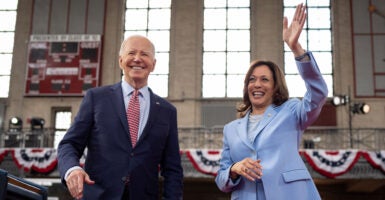 Joe Biden in a blue suit and Kamala Harris in a light blue pantsuit