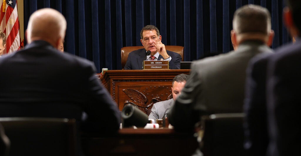 Mark Green in a suit behind a podium